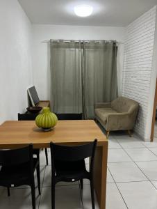 a living room with a table and a couch at APARTAMENTO PROXIMO À UFPE in Recife