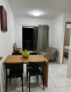 a living room with a wooden table and chairs at APARTAMENTO PROXIMO À UFPE in Recife
