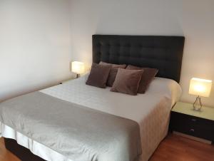 a bedroom with a large bed with two lamps at Apartment Airport Barcelona Premium in Viladecáns +72 photos