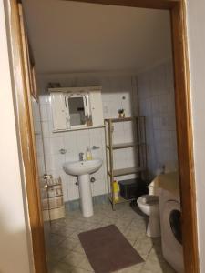 a small bathroom with a sink and a toilet at The Quiet Corner in Kalamata