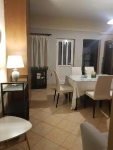 a living room with a white table and chairs at The Quiet Corner in Kalamata