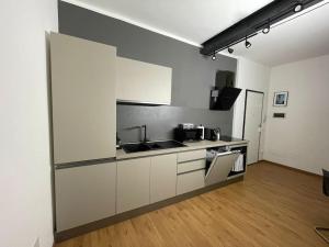 a kitchen with a sink and a microwave at Cairoli Apartment in Ravenna