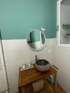 a bathroom with a sink and a mirror at Cairoli Apartment in Ravenna