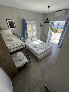 a room with two beds and a balcony at Princess Sissy in Ios Chora