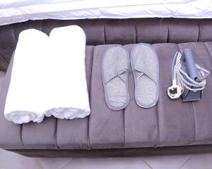 two pairs of shoes sitting on a couch at Peaceful Home in Kampala