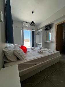 a large bed in a room with a window at Princess Sissy in Ios Chora