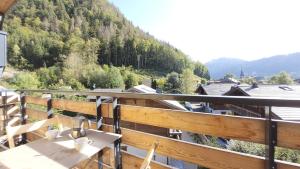 a balcony with a table and a view of a mountain at Oree de Morzine 32B in Montriond +7 photos