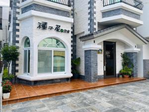 une maison avec une terrasse couverte à l'avant et une porte dans l'établissement Seed House, à Taïtung 36 autres photos