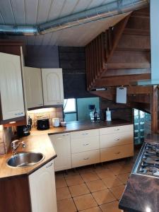 a kitchen with white cabinets and a sink at Paritalohuoneisto keskustassa in Valkeakoski