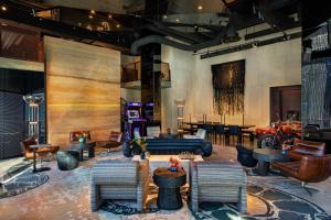 a lobby with chairs and a couch and tables at Moxy Downtown Los Angeles in Los Angeles