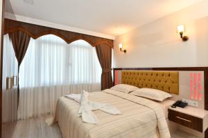 a bedroom with a large bed and a window at Sea Moon Hotel in Istanbul