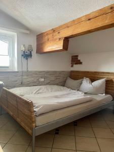 a large bed in a room with a wooden ceiling at Gästezimmer Lercher in Sankt Veit im Pongau
