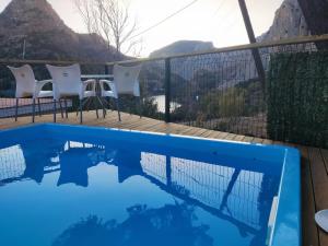 a swimming pool with a view of the mountains at Refugio de El Chorro in El Chorro