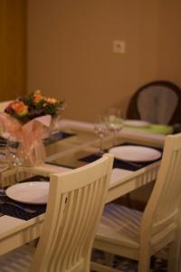 索姆河畔的聖瓦列里的住宿－Maison familiale et cosy à la mer，餐桌、两把椅子、一张桌子、盘子和玻璃杯