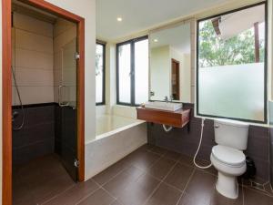 uma casa de banho com um WC, um chuveiro e um lavatório. em 360 Resort em Sihanoukville