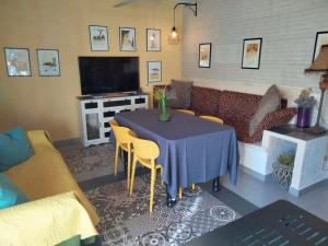 a living room with a table and a couch at Casa rural La Libelula Ayna in Ayna