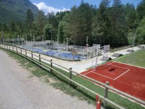 
a field with a fence and a tennis court at Camping L'Espelt in La Pobla de Lillet
