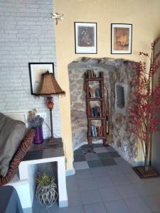 a living room with a couch and a stone wall at Casa rural La Libelula Ayna in Ayna