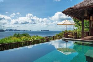 a swimming pool with a view of the ocean at Six Senses Yao Noi in Ko Yao Noi