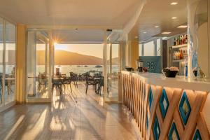 a dining room with a view of the ocean at Hotel Portoconte in Porto Conte