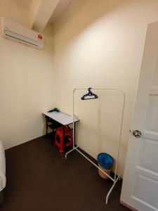 a room with a table and a desk with a heater at 22A HOSTEL in George Town