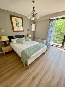 a bedroom with a bed and a large window at Stara Plebania in Ponice