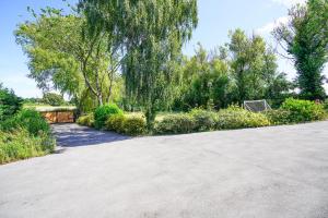 a driveway in a park with trees and bushes at Spa Home with Pool Sauna Hot Tub Cocktail Bar in Sheffield