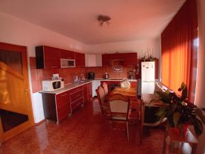 a kitchen with a table and a white microwave at Casa Larisa in Vişeu de Sus