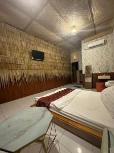 a bedroom with two beds and a tv on a wall at HomeStay 888 in Can Tho