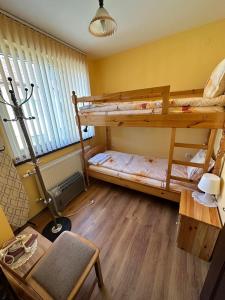 a room with two bunk beds and a table at Tainov House in Samokov