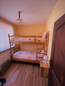 a bedroom with two bunk beds in a room at Tainov House in Samokov