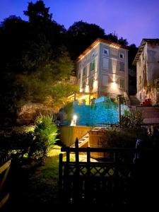 a large house with lights on top of it at night at La Casa sulla collina del Castello in Breno