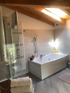 a large bathroom with a tub and a shower at La Casa sulla collina del Castello in Breno