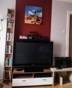 a large flat screen tv on a white entertainment center at Apartment Am Radweg in Wetzlar