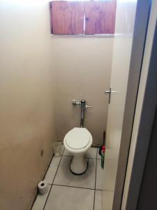 a small bathroom with a toilet in a stall at Kingswood Flats in Pretoria