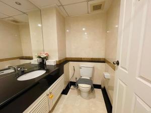 a bathroom with a toilet and a sink at Supalai Oriental Place in Bangkok