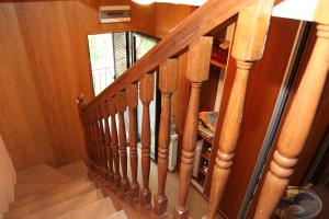 a staircase with wooden railings in a house at Natalia Rooms Old Town in Herceg-Novi +2 photos