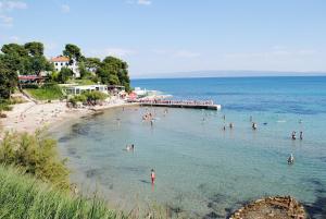 a group of people in the water at a beach at Fantastic Apartment in Split