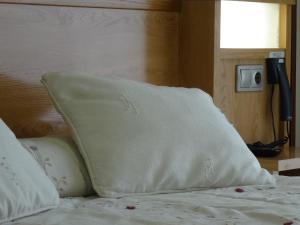 a white pillow sitting on top of a bed at Hotel Akelarre in Santiago de Compostela
