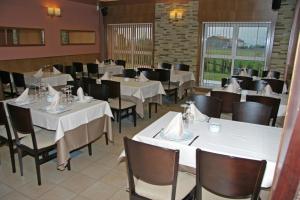a dining room with white tables and chairs at Hotel Akelarre in Santiago de Compostela