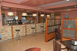a bar in a restaurant with tables and chairs at Hotel Akelarre in Santiago de Compostela