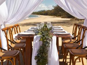 a table set up for a wedding on the beach at Pullman Palm Cove Sea Temple Resort & Spa in Palm Cove
