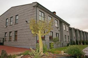 a building with a tree in front of it at Hotel Akelarre in Santiago de Compostela