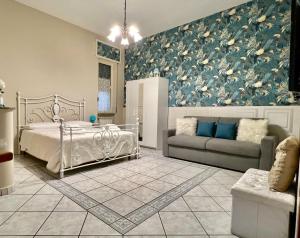 a bedroom with a bed and a couch at Royal House Trecase in Trecase