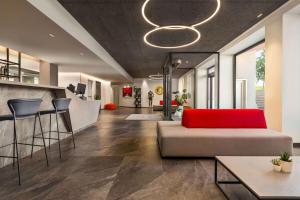 a living room with a couch and a bar at Amedia Hotel Milan, Trademark Collection by Wyndham in Milan