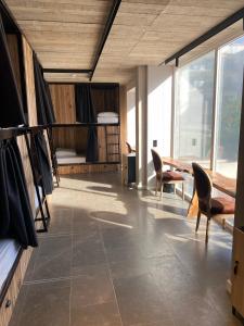 a room with a table and chairs and a bedroom at Zarautz Surf House in Zarautz