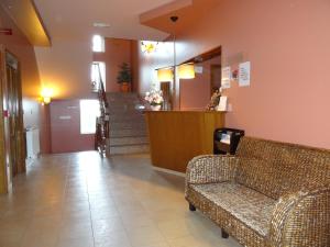 a lobby with a couch and stairs in a building at Hotel Akelarre in Santiago de Compostela