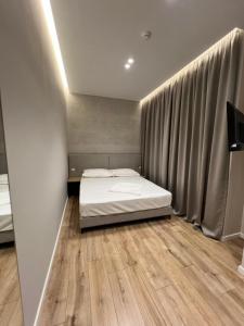 Postel nebo postele na pokoji v ubytování Enzo rooms & apartment Blloku