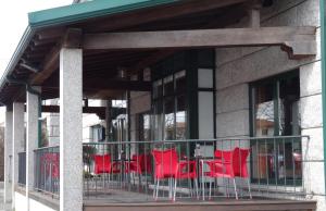 a group of red chairs sitting on a balcony at Hotel Akelarre in Santiago de Compostela