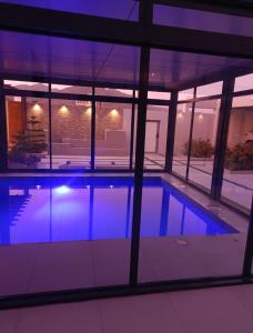 a swimming pool in a building at night at استراحة رافلز in Sayq